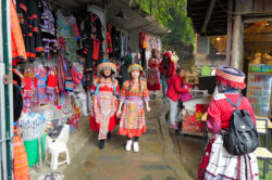 Many tourists wearing traditional gear to take photos by the river