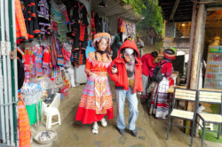 Many tourists wearing traditional gear to take photos by the river